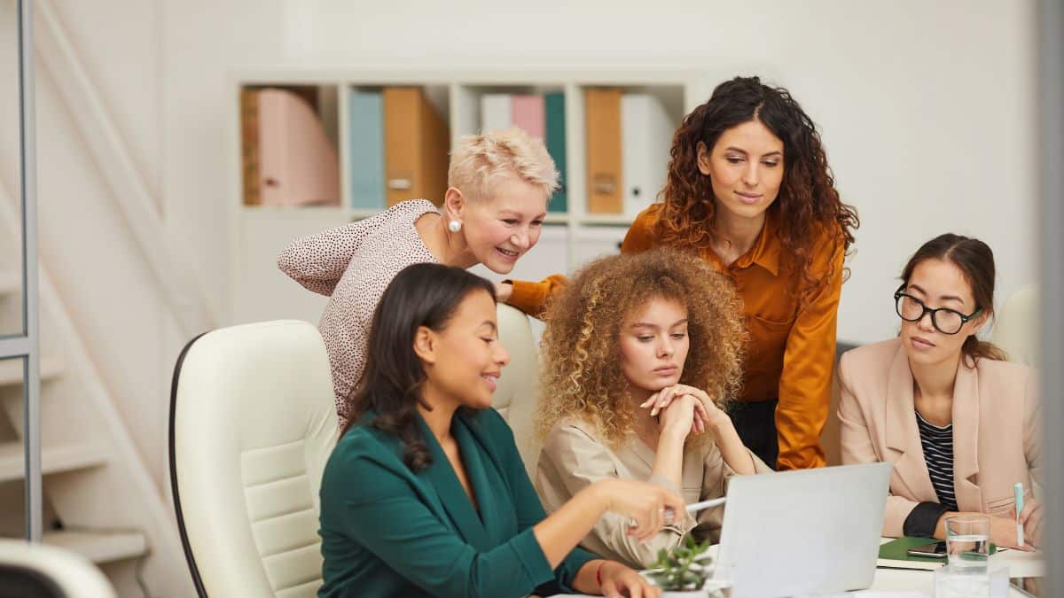 Groupe de professionnelles analysant ensemble les compétences à mettre sur un CV lors d'une réunion de travail